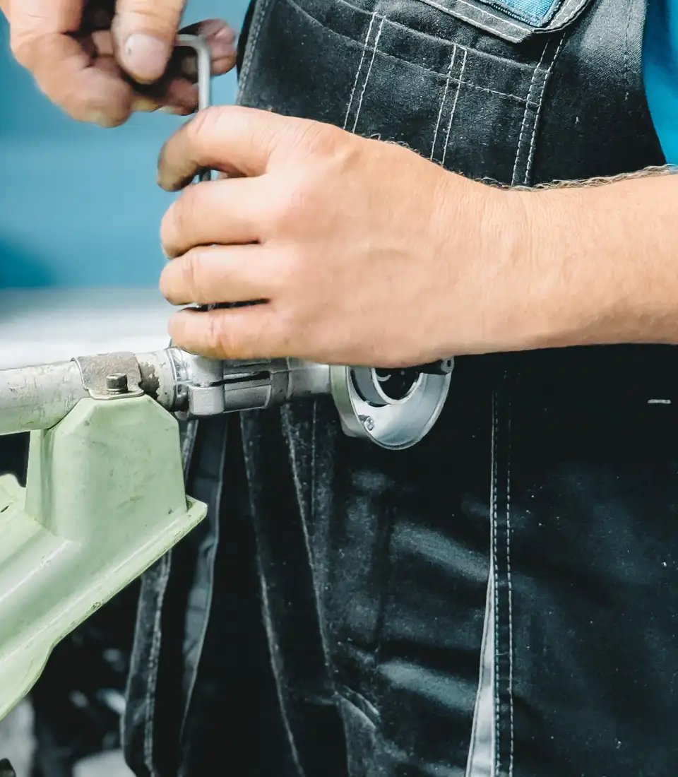 Plumber repairing a pipe with a wrench